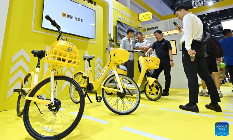 Visitors learn about various bike sharing service solutions at the environmental services exhibition of the 2023 China International Fair for Trade in Services (CIFTIS) in Beijing, capital of China, Sept. 2, 2023. Themed Opening-up leads development, cooperation delivers the future, the 2023 CIFTIS is being held in Beijing from Sept. 2 to 6 and features over 200 varied events, including forums, negotiations, and summits. (Photo: Xinhua)