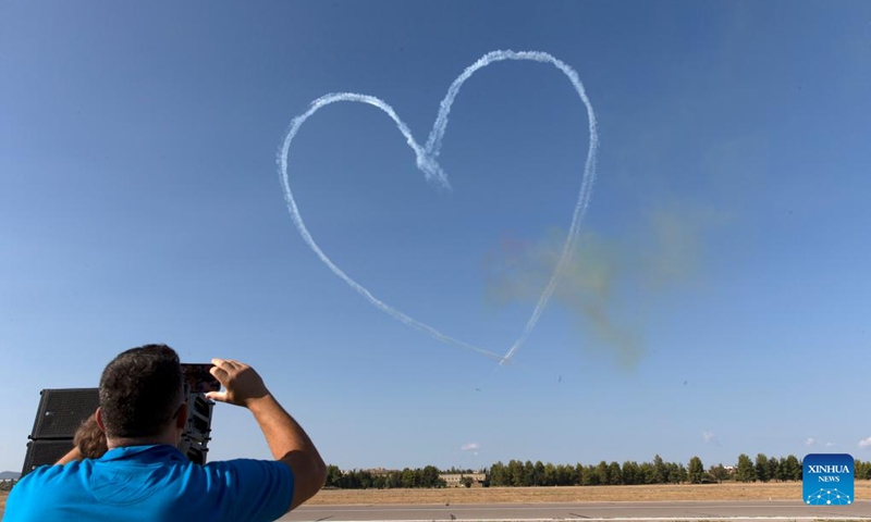 A spectator takes photos of the performance of aircraft from the United Arab Emirates during an air show at the Tanagra Air Base, some 70 kilometers north of Athens, Greece on Sept. 2, 2023. Athens Flying Week 2023 was held on Sept. 2 and Sept. 3 at the Tanagra Air Base. Photo: Xinhua