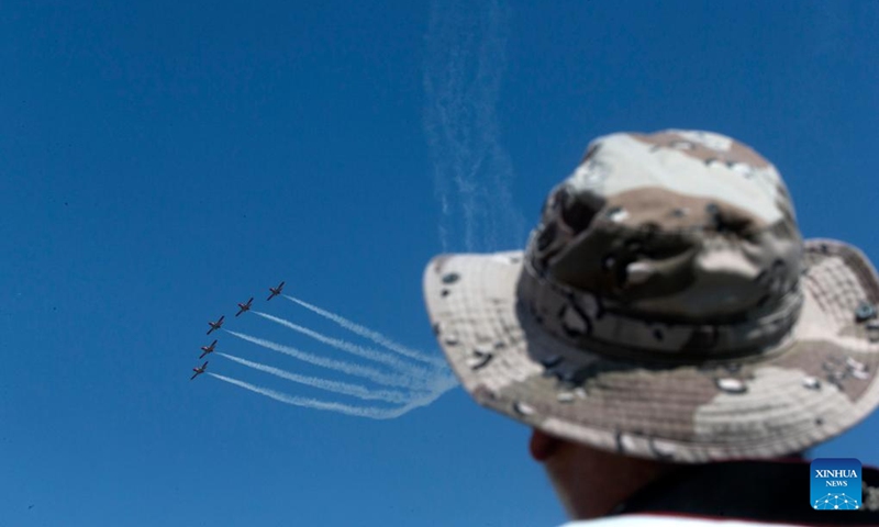 A spectator watches the performance of Spanish aircraft during an air show at the Tanagra Air Base, some 70 kilometers north of Athens, Greece on Sept. 2, 2023. Athens Flying Week 2023 was held on Sept. 2 and Sept. 3 at the Tanagra Air Base. Photo: Xinhua
