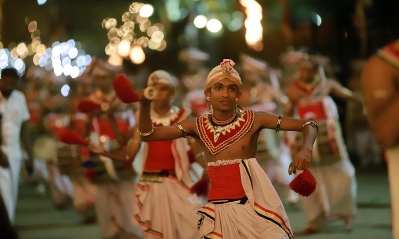 Dancers perform in front of the historic Buddhist Temple of the Tooth during a procession celebrating the Esala Perahera festival in Kandy, Sri Lanka, on Aug. 30, 2023. Photo: Xinhua
