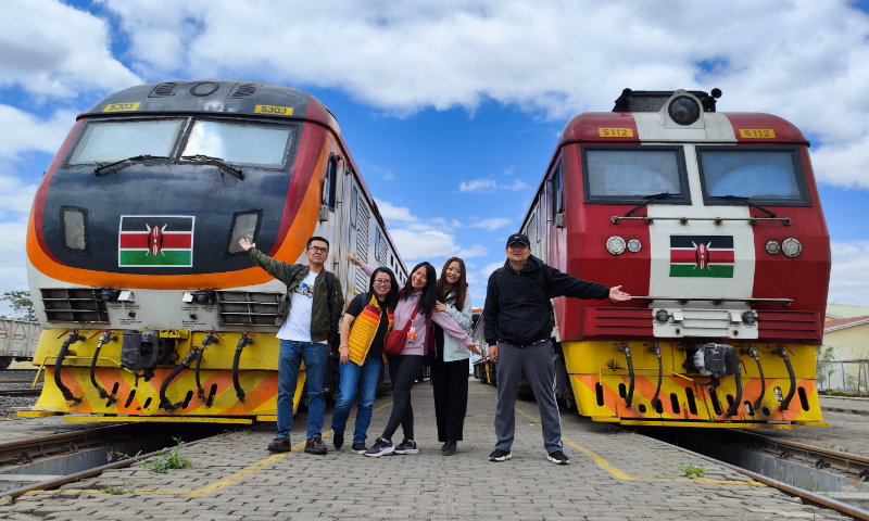 Global Times reporters pose in front of trains at Nairobi station of the Mombasa-Nairobi Standard Gauge Railway in Kenya on August 7, 2023. Photo: GT
