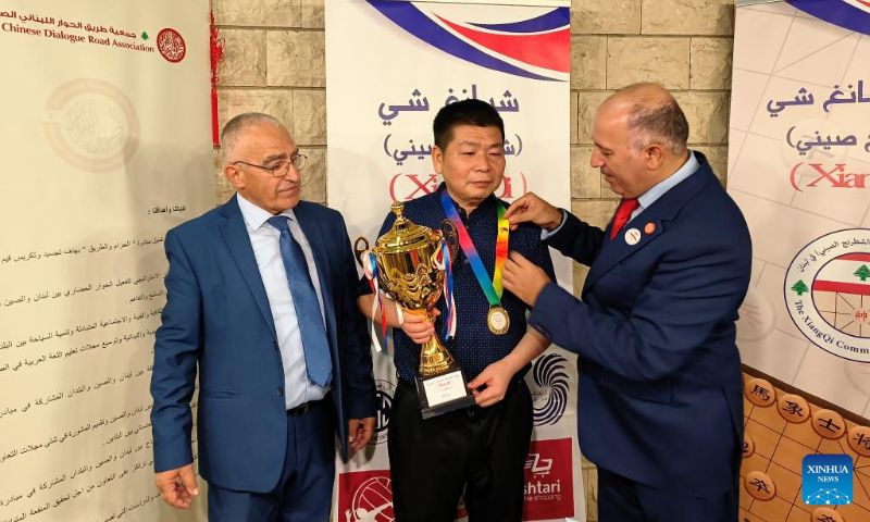 Chinese participant Li Lei (C) is awarded after winning the first place of Lebanese-Chinese XiangQi Friendship Championship in Deir el Qamar, Mount Lebanon Governorate, Lebanon, on Sept. 10, 2023. (Photo by Huang Shuai/Xinhua)