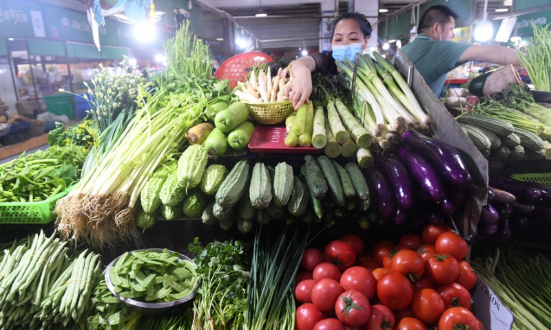 A stall owner arranges vegetables at a market in Nanning, capital of South China's Guangxi Zhuang Autonomous Region, July 9, 2022. Photo: Xinhua