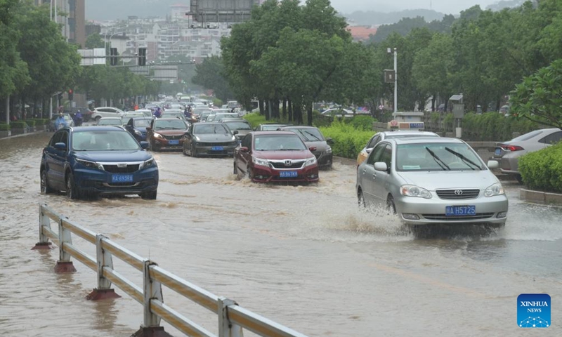 Motor vehicles pass through floodwater on a road in downtown Fuzhou, southeast China's Fujian Province, on Sept. 6, 2023. More than 36,000 people in Fuzhou, capital of southeast China's Fujian Province, have been temporarily evacuated as Typhoon Haikui brought heavy rainstorms, authorities said Wednesday.(Photo: Xinhua)