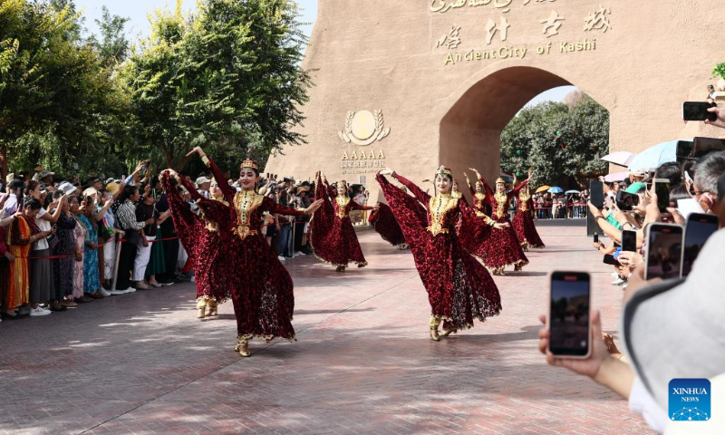 Performers dance at the ancient city of Kashgar scenic area in Kashgar, northwest China's Xinjiang Uygur Autonomous Region, Sept. 7, 2023. The ancient city of Kashgar, located in southwestern Xinjiang, is the largest complex of raw earth buildings still in use in the world. (Xinhua/Lan Hongguang)