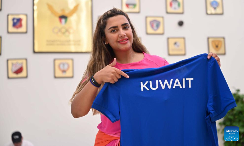 An athlete displays a uniform of the Kuwaiti national team for the upcoming Hangzhou Asian Games at the Kuwait Olympic Committee in Jahra Governorate, Kuwait, Sept. 10, 2023. (Photo by Asad/Xinhua)