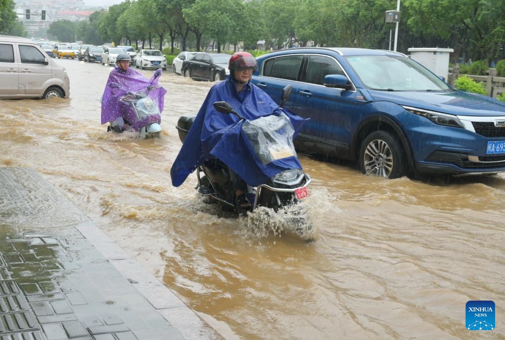 People ride through water on a flooded road in Gulou District of Fuzhou, southeast China's Fujian Province, Sept. 6, 2023. Typhoon Haikui, the 11th typhoon of this year, made landfall in the coastal areas of Fujian Province on Tuesday.(Photo: Xinhua)