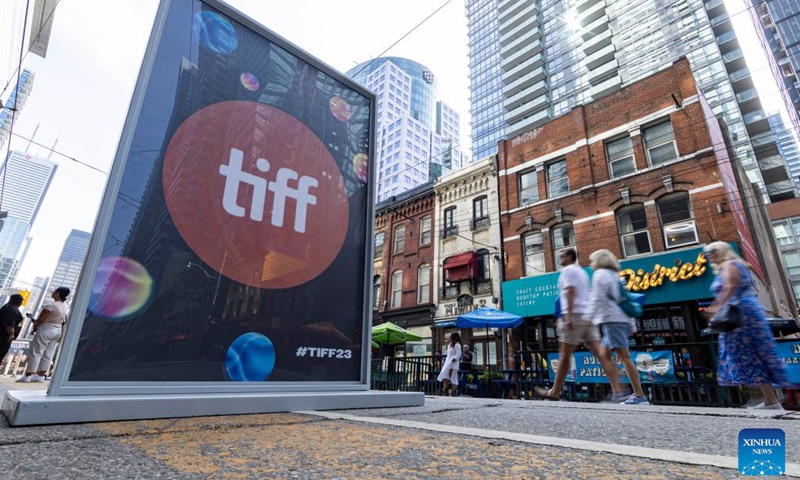 People walk past a Toronto International Film Festival (TIFF) poster in Toronto, Canada, on Sept. 7, 2023. The TIFF kicked off here on Thursday.(Photo: Xinhua)
