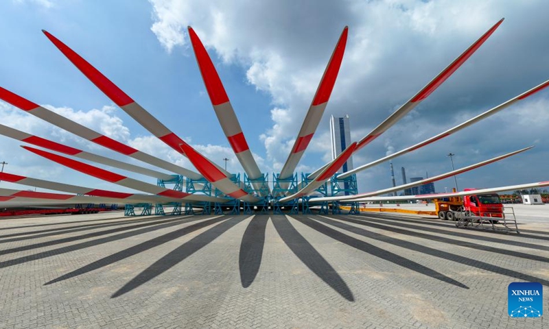 This aerial photo taken on Sept. 8, 2023 shows wind turbine blades ready for transportation at a port in Yancheng, east China's Jiangsu Province. Yancheng has boosted green and low-carbon development by advancing new energy industries such as wind and photovoltaic power in recent years. Photo: Xinhua