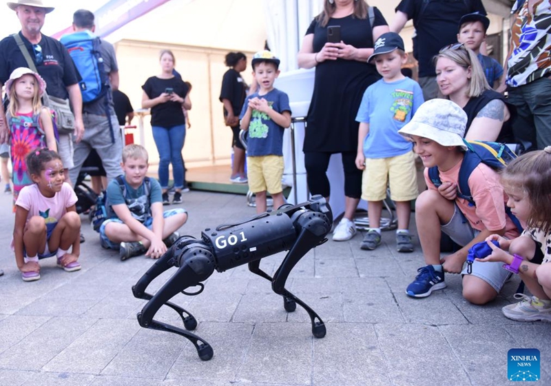 Children interact with a robot dog in Vienna, Austria on Sept. 9, 2023. Public Transport Day was held here on Saturday with various activities and entertainment. Photo: Xinhua