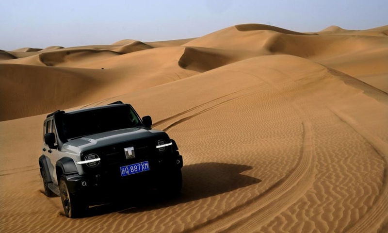 A car drives in a desert scenic spot in Makit County of Kashgar, northwest China's Xinjiang Uygur Autonomous Region, Sept. 7, 2023. Makit County, located on the southwestern rim of the Taklimakan Desert, has taken advantage of its natural resources to develop tourism and provide jobs for the local people. Photo: Xinhua