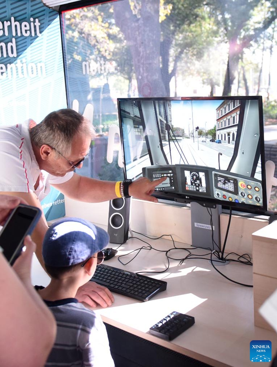 A kid experiences a tram driving simulator in Vienna, Austria, on Sept. 9, 2023. Public Transport Day was held here on Saturday with various activities and entertainment. Photo: Xinhua