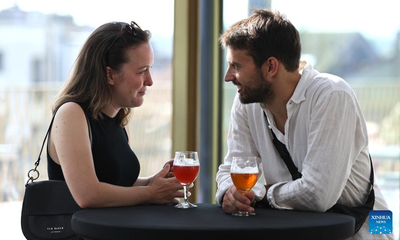 Visitors enjoy beer at a rooftop bar of the Belgian Beer World in Brussels, Belgium, Sept. 9, 2023. The Belgian Beer World, which showcases Belgium's brewing tradition through a series of interactive exhibits and workshops, opened its doors to the public here on Saturday. Photo: Xinhua