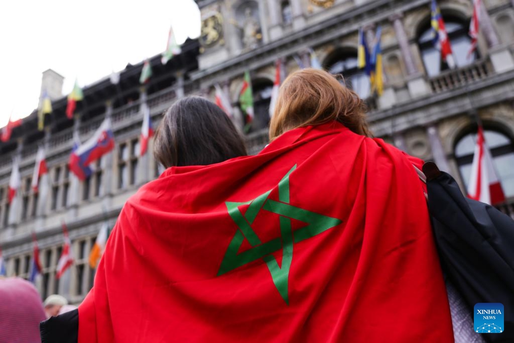 People with a flag of Morocco attend a memorial service for victims of the earthquake in Morocco, in central Antwerp, Belgium, on Sept. 11, 2023.(Photo: Xinhua)