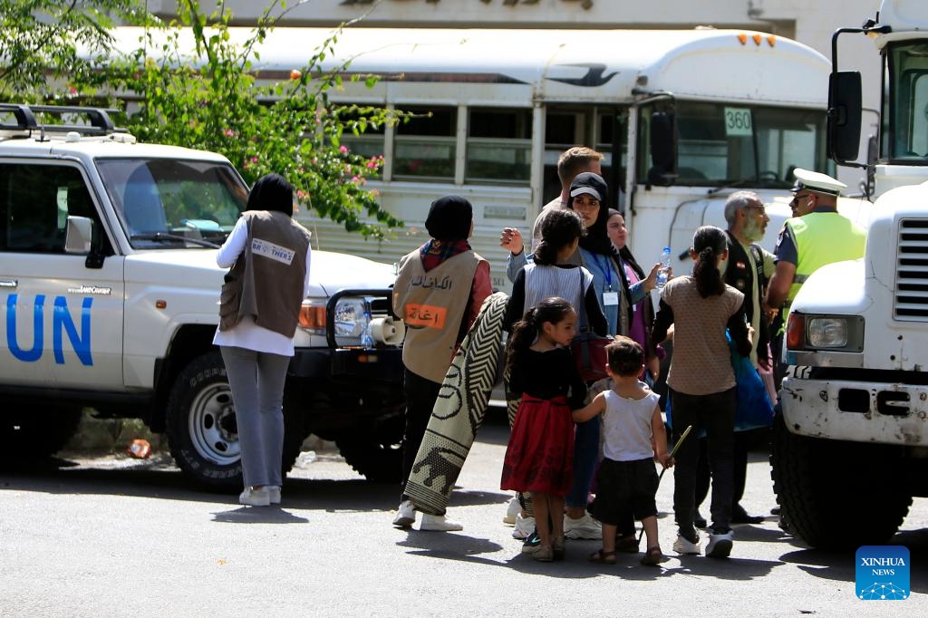 Palestinians from Ain Al-Helweh camp prepare to move from a shelter in Sidon to a center of the United Nations Relief and Works Agency for Palestine Refugees (UNRWA) in Mount Lebanon Governorate, Lebaon, Sept. 12, 2023. The latest round of armed clashes between members of the Fatah Movement and Islamic militants in the Ain Al-Helweh Palestinian refugee camp broke out last Thursday evening and intensified in the following days(Photo: Xinhua)