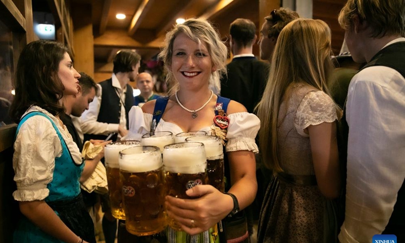 A staff member serves beer at the Oktoberfest in Munich, Germany, Sept. 16, 2023. The 188th Oktoberfest, one of the largest folk festivals in Germany, officially opened here on Saturday. It is expected to conclude on Oct. 3. (Xinhua/Zhang Fan)