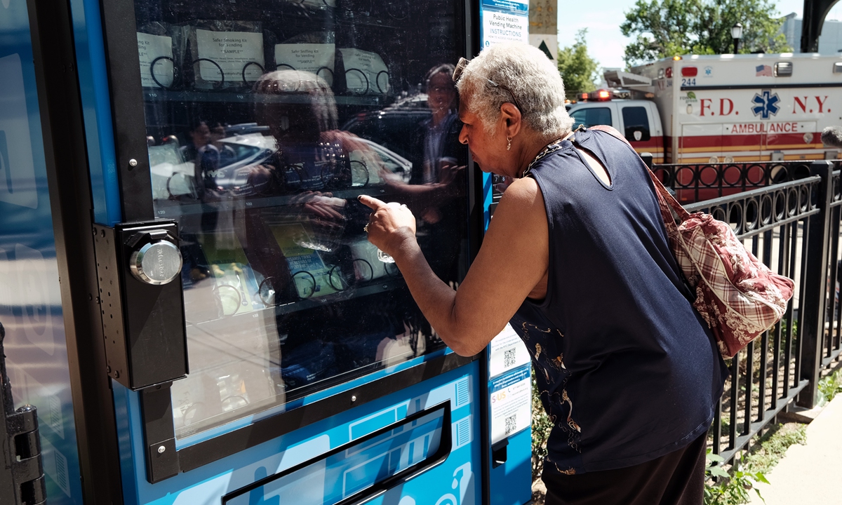 A man uses a new vending machine in Brooklyn that will disperse fentanyl test strips and naloxone as well as hygiene kits, maxi pads, Vitamin C, and COVID-19 tests for free on June 5, 2023 in New York City. Photo: VCG