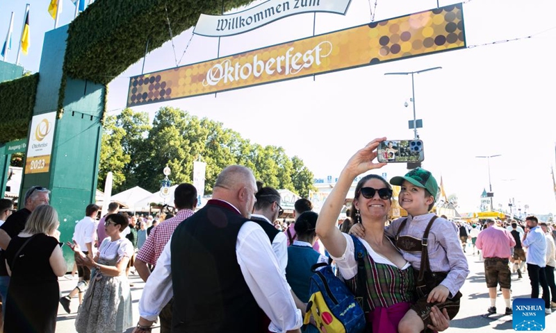 People take selfies at the Oktoberfest in Munich, Germany, Sept. 16, 2023. The 188th Oktoberfest, one of the largest folk festivals in Germany, officially opened here on Saturday. It is expected to conclude on Oct. 3. (Xinhua/Zhang Fan)