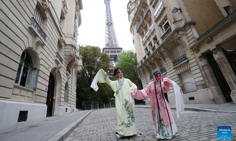 Kunqu Opera actor Shi Xiaming (L) and actress Kong Aiping stage a flash mob performance near the Eiffel Tower in Paris, France, Sept. 13, 2023. Artists from east China's Jiangsu Province presented the charm of Kunqu Opera through a series of flash mob performances near the iconic landmarks in Paris. (Photo: Xinhua)