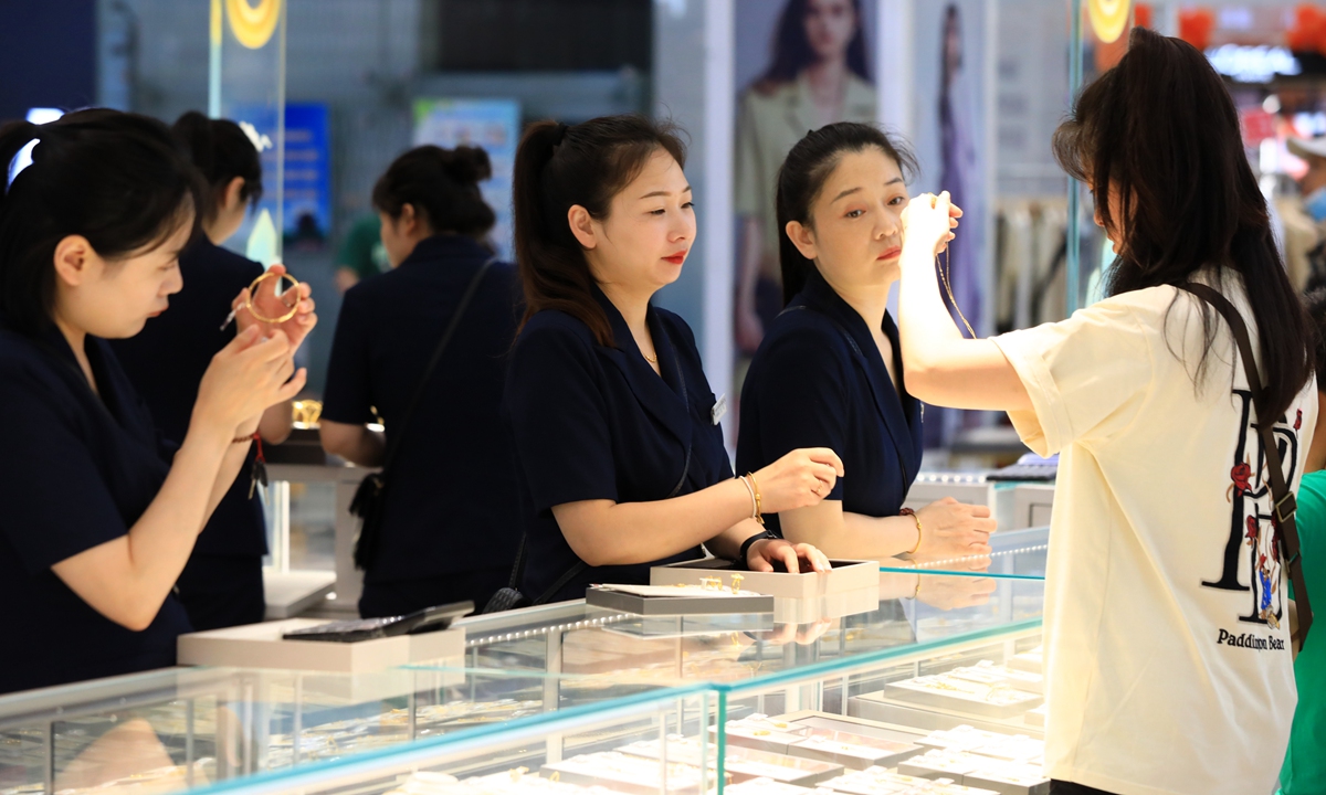 A consumer browses gold products at a jewelry store in Huai'an City, East China's Jiangsu Province on September 17, 2023. 
With the Mid-Autumn Festival and National Day holidays approaching, gold, silver and jewelry in China's major gold stores are selling well. Photo: VCG