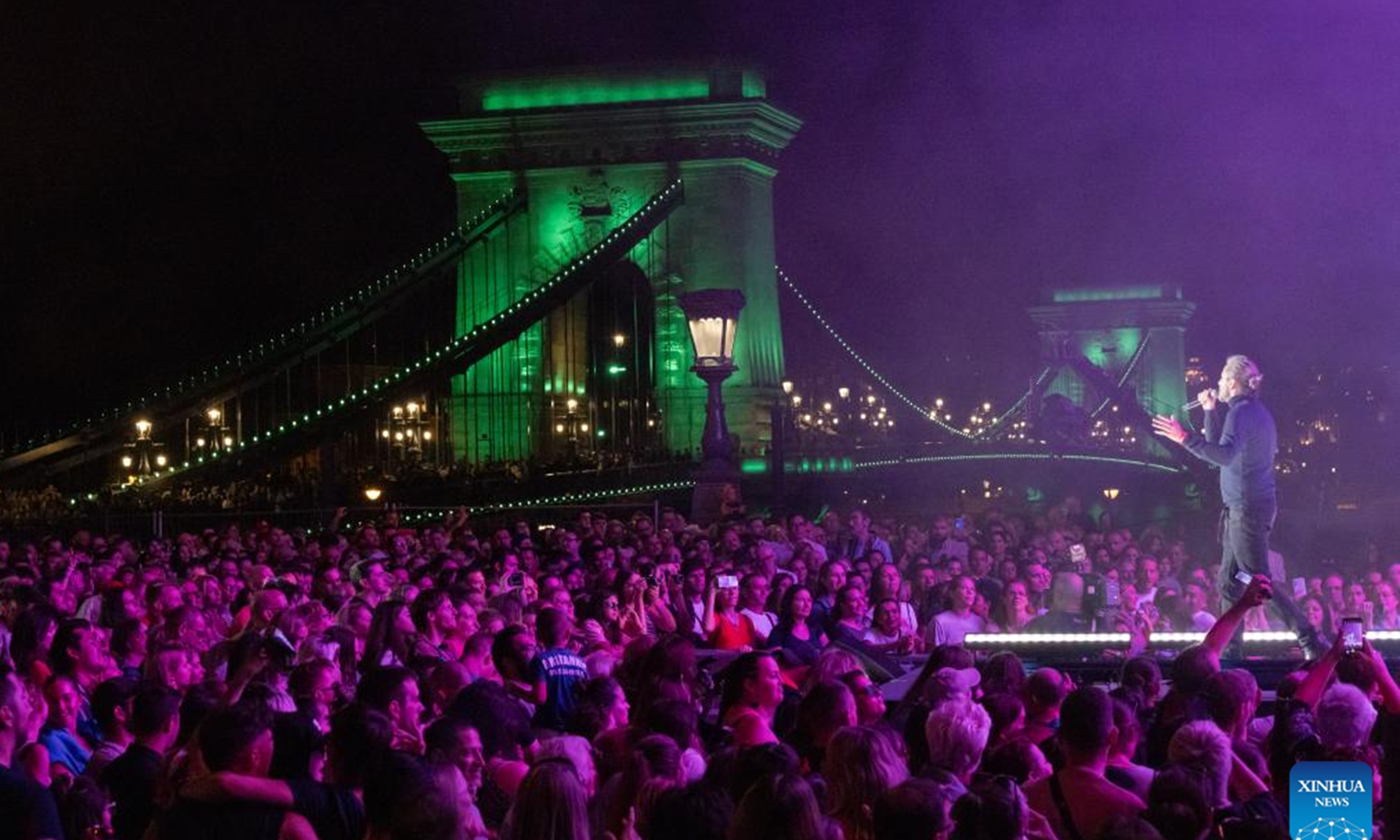 People enjoy the night view by Budapest's landmark Chain Bridge during the Chain Bridge Festival celebrating Budapest's 150th birthday in Budapest, Hungary on Sept. 16, 2023. In 1873, Buda, Pest and Obuda were unified into one single city, naming the city Budapest. (Photo by Attila Volgyi/Xinhua)
