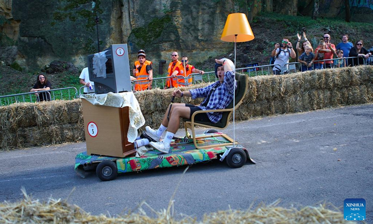 A competitor drives a vehicle imitating a living room during the Red Bull Kary race, a competition of handcrafted, non-motorized vehicles, in Prague, the Czech Republic, on Sept. 16, 2023. A total of 40 selected teams presented their home-made vehicles during the event at Park Kralovka in the Czech capital on Saturday. (Photo by Dana Kesnerova/Xinhua)






