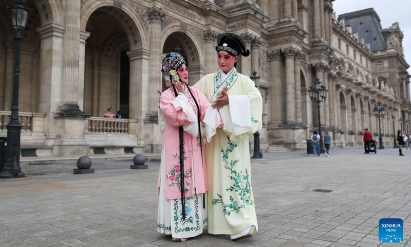 Kunqu Opera actor Shi Xiaming (R) and actress Kong Aiping stage a flash mob performance near the Louvre Museum in Paris, France, Sept. 13, 2023. Artists from east China's Jiangsu Province presented the charm of Kunqu Opera through a series of flash mob performances near the iconic landmarks in Paris. (Photo: Xinhua)