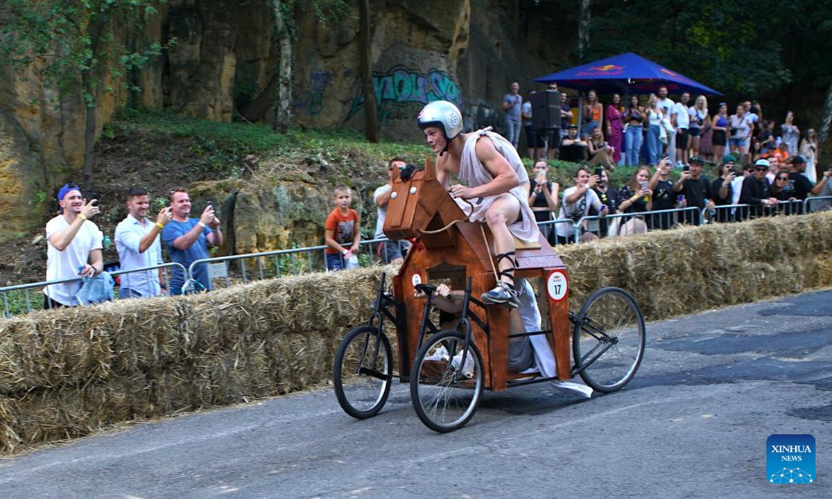 A competitor drives a bed-shaped vehicle during the Red Bull Kary race, a competition of handcrafted, non-motorized vehicles, in Prague, the Czech Republic, on Sept. 16, 2023. A total of 40 selected teams presented their home-made vehicles during the event at Park Kralovka in the Czech capital on Saturday. (Photo by Dana Kesnerova/Xinhua)





