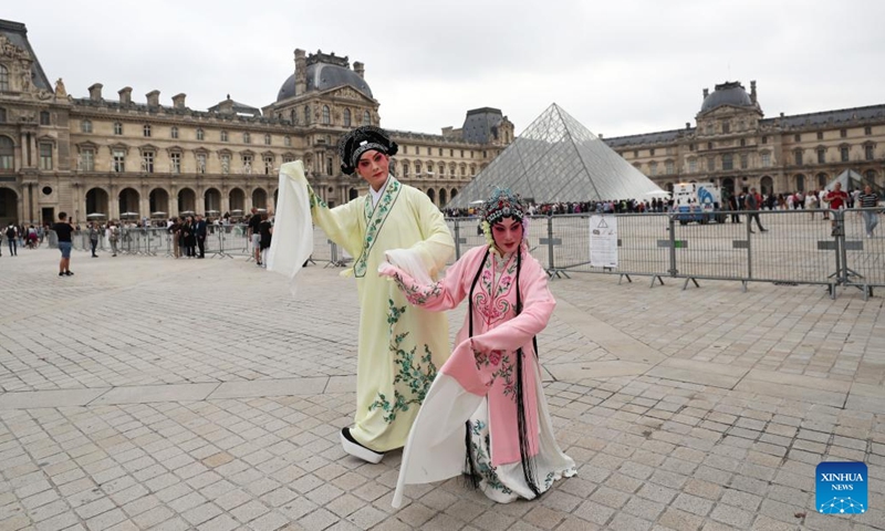 Kunqu Opera actor Shi Xiaming (L) and actress Kong Aiping stage a flash mob performance near the Louvre Museum in Paris, France, Sept. 13, 2023. Artists from east China's Jiangsu Province presented the charm of Kunqu Opera through a series of flash mob performances near the iconic landmarks in Paris. (Photo: Xinhua)