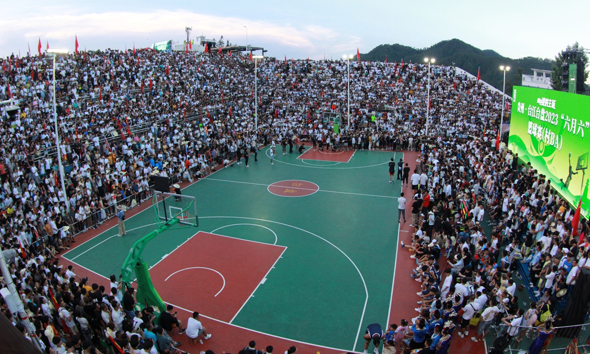 Spectators wait before the start of a Village BA game in Taipan village, Guizhou Province in July. Photo: VCG