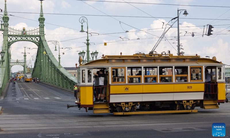 People visit a nostalgic vehicle exhibition in downtown Budapest, Hungary on Sept. 17, 2023. The exhibition was held here on Sept. 16 and 17, offering people an opportunity to meet aged trams and buses.(Photo: Xinhua)