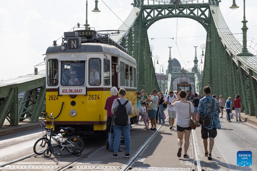 People visit a nostalgic vehicle exhibition in downtown Budapest, Hungary on Sept. 17, 2023. The exhibition was held here on Sept. 16 and 17, offering people an opportunity to meet aged trams and buses.(Photo: Xinhua)