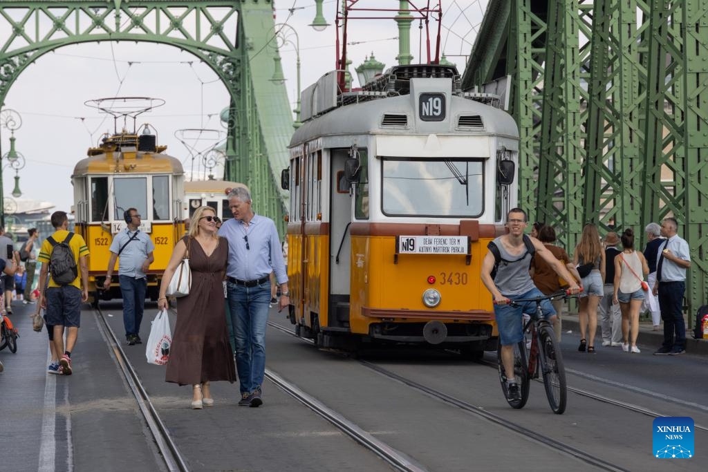 People visit a nostalgic vehicle exhibition in downtown Budapest, Hungary on Sept. 17, 2023. The exhibition was held here on Sept. 16 and 17, offering people an opportunity to meet aged trams and buses.(Photo: Xinhua)