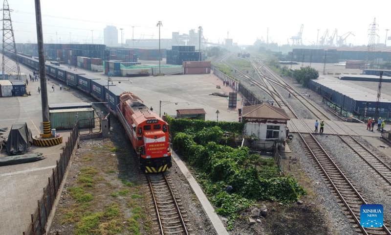 This aerial photo shows a freight train bound for Ulan Bator, Mongolia, pulling out of a station in Tianjin Port in north China's Tianjin, Sept. 18, 2023. Since the beginning of this year, north China's Tianjin Port has seen nearly 500 China-Europe and China-Central Asia freight train trips. The freight train service is of great significance to further promote the coordinated development of the international logistics in the Beijing-Tianjin-Hebei region.(Photo: Xinhua)