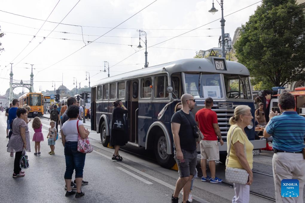 People visit a nostalgic vehicle exhibition in downtown Budapest, Hungary on Sept. 17, 2023. The exhibition was held here on Sept. 16 and 17, offering people an opportunity to meet aged trams and buses.(Photo: Xinhua)