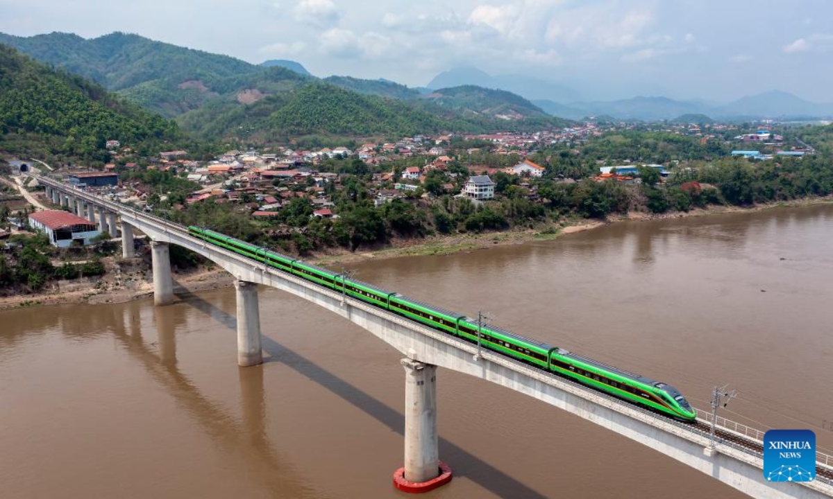 A train drives on the China-Laos Railway's Luang Prabang cross-Mekong River super major bridge in Laos, May 28, 2023. The bridge, some 230 km north of Lao capital Vientiane, has a total length of 1,458.9 meters and is composed of 28 span T-beams and six spans continuous beams. It is the most difficult and most technically complex bridge on the entire railway. Photo:Xinhua