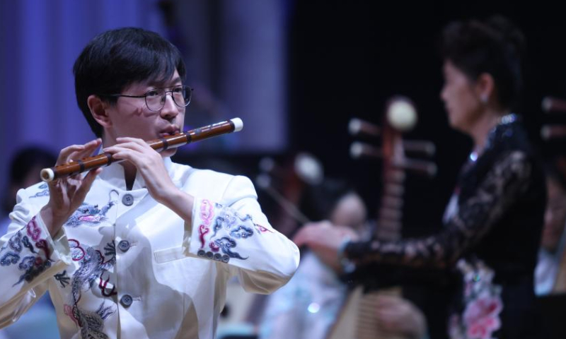 A member of China's Nanjing University's Traditional Instruments Orchestra plays flute during a concert of Chinese classical music in Ljubljana, Slovenia, on Oct. 2, 2023. (Photo by Zeljko Stevanic/Xinhua)