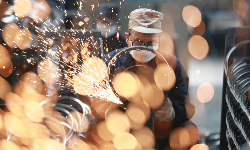 Workers polish bicycle steel rings sold overseas at a foreign trade enterprise in Tianmushan town, East China's Zhejiang Province, on October 5, 2023. Photo: cnsphoto
