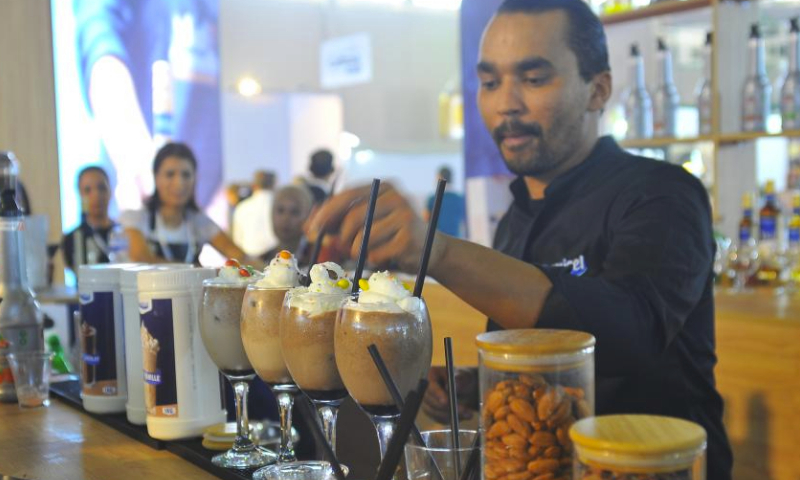 A man prepares a coffee drink at the international coffee exhibition Spring of Coffee in Tunis, Tunisia, on Oct. 5, 2023. (Photo by Adel Ezzine/Xinhua)
