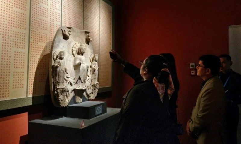Foreign journalists appreciate an exhibition of ancient Chinese Buddhist statues at the Poly Art Museum in Beijing on Friday. Photo: Qian Jiayin/GT