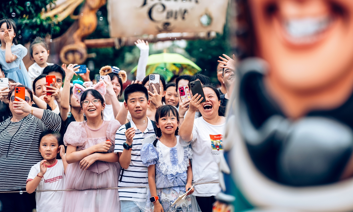 People watch the parade performance at Shanghai Disneyland on June 26, 2023. Photo: VCG