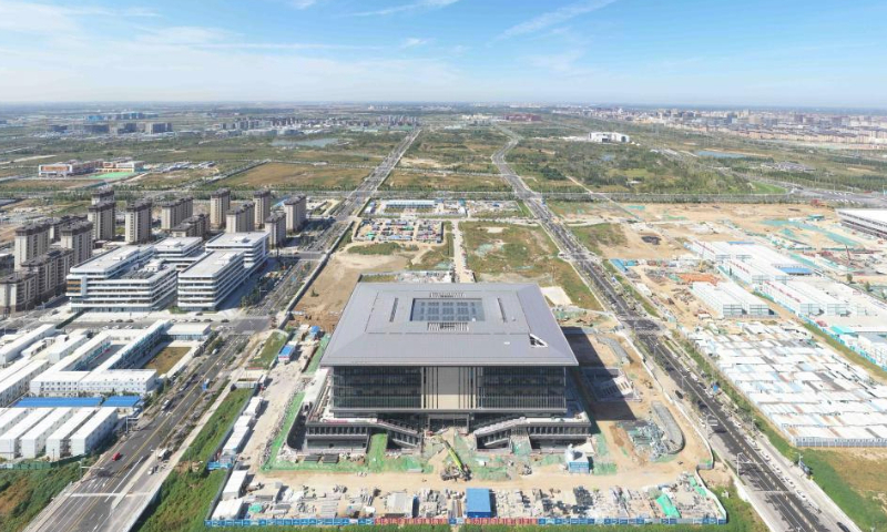 This aerial photo taken on Oct. 1, 2023 shows the construction site of a library at the university zone in Xiong'an New Area, north China's Hebei Province. The construction of key projects including Xiong'an sports center, the Xiong'an branch of Beijing-based Xuanwu Hospital, and Xiong'an innovation and research institute under the Chinese Academy of Sciences is advancing steadily at the start-up area in Xiong'an New Area. (Xinhua/Zhu Xudong)