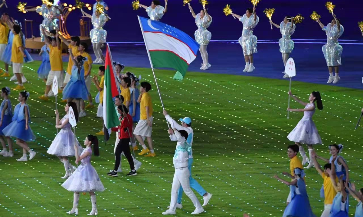 Uzbek national flag and athletes enter the main stadium of the Hangzhou Asian Games on October 8, 2023. Photo: Courtesy of Uzbek Embassy in Beijing