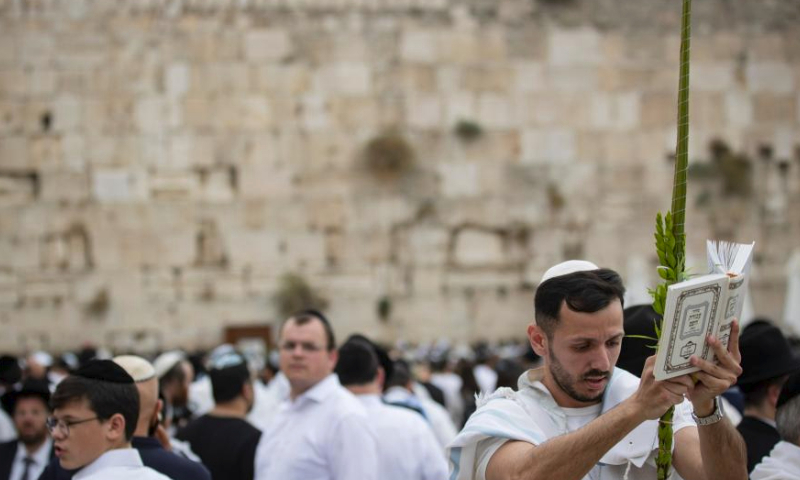 Jewish worshippers attend the Priestly Blessing during Sukkot at the Western Wall in the Old City of Jerusalem, on Oct. 4, 2023. The Sukkot, or Feast of Tabernacles, falling from sunset of Sept. 29 to sunset of Oct. 6 this year, is a biblical week-long holiday that recollects the 40 years of travel in the desert after the Exodus from slavery in Egypt. (Xinhua/Chen Junqing)