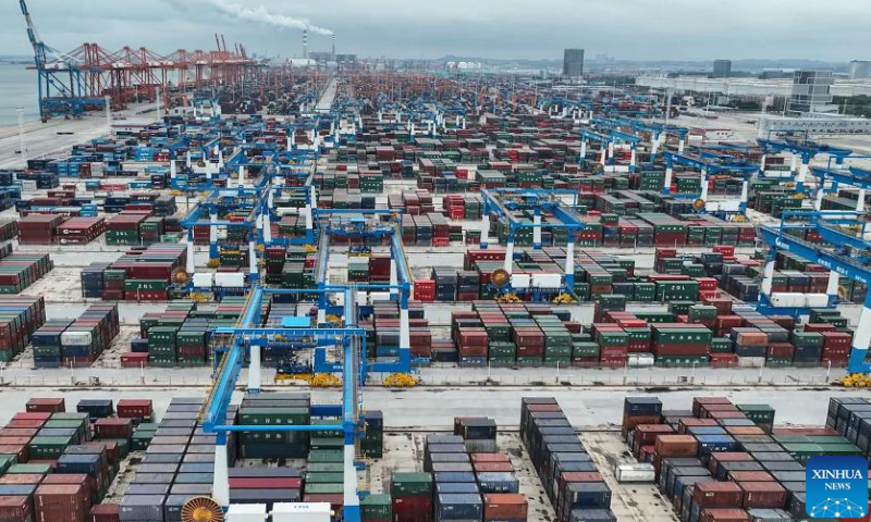 This aerial photo taken on Oct. 2, 2023 shows a container storage area at Qinzhou Port in Qinzhou, south China's Guangxi Zhuang Autonomous Region. Container throughput of the New International Land-Sea Trade Corridor witnessed growth in the first three quarters of 2023, according to railway authorities in south China's Guangxi Zhuang Autonomous Region. During this period, some 633,000 twenty-foot equivalent unit (TEU) containers of goods were transported by rail-sea intermodal trains through the corridor, up 14 percent year on year, data from the China Railway Nanning Group Co., Ltd. showed. Launched in 2017, the New International Land-Sea Trade Corridor is a trade and logistics passage jointly built by provincial-level regions in western China and ASEAN members. The trade corridor has developed rapidly over the years, covering 61 cities in 18 provincial-level regions in China and expanding its reach to 393 ports in 119 countries and regions.（photo：Xinhua）