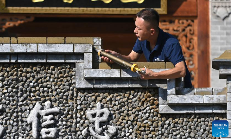 Villager Li Tan'en works at a theater in Qikou ancient town of Linxian County, north China's Shanxi Province, Aug. 2, 2023. In 2020, Li ended his career as a migrant worker and served as a staff member for a local theater in the Qikou ancient town. The job brings him an annual income of more than 50,000 yuan (about 6,848 U.S. dollars). Qikou, an ancient riverine town along the Yellow River, was an important trade ferry in history. However, with the development of land transportation, the Qikou ancient town declined in terms of trade volume, leaving many of its historical buildings in disrepair. In recent years, local authorities have carried out protection and restoration of historical buildings and ancient dwellings in the Qikou ancient town. At the same time, the integrated development of culture and tourism is also promoted. Today the ancient town has become a popular tourist attraction. More than 5,000 people out of a population of about 30,000 in the town are engaged in the tourism industry. (Photo:Xinhua)