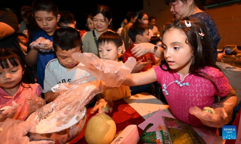 Children take part in a mooncake making activity during a mid-autumn festival gala in Malacca, Malaysia, Sept. 27, 2023. (Xinhua/Cheng Yiheng)
