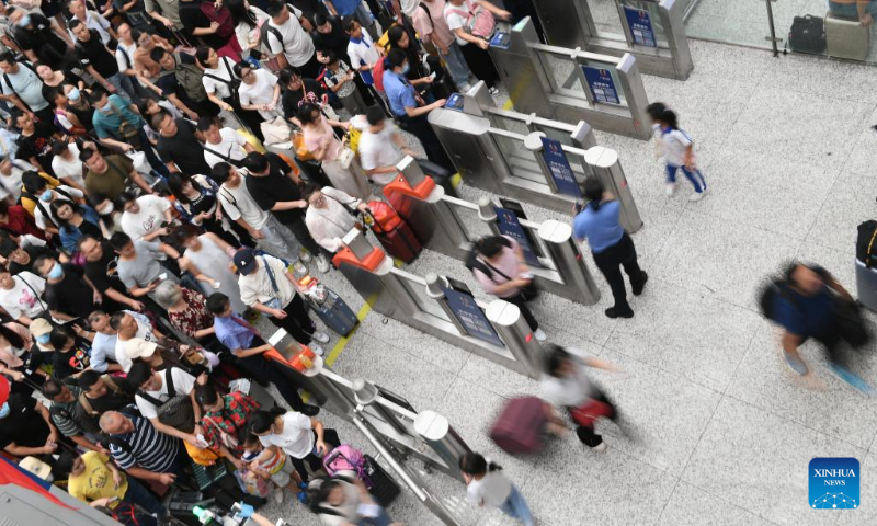 Passengers go through ticket gates at Shenzhen North Railway Station in Shenzhen, south China's Guangdong Province, Sept. 28, 2023. The Mid-Autumn Festival and National Day holiday period, which will last from Sept. 29 to Oct. 6 this year, is a peak travel and tourism season in China. (Xinhua/Mao Siqian)