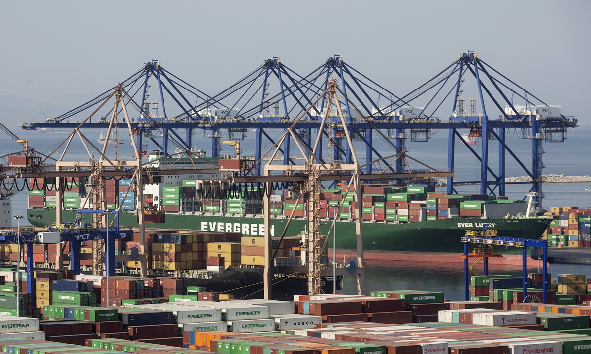 A container ship sits moored at the freight terminal at Piraeus Port. File photo: VCG