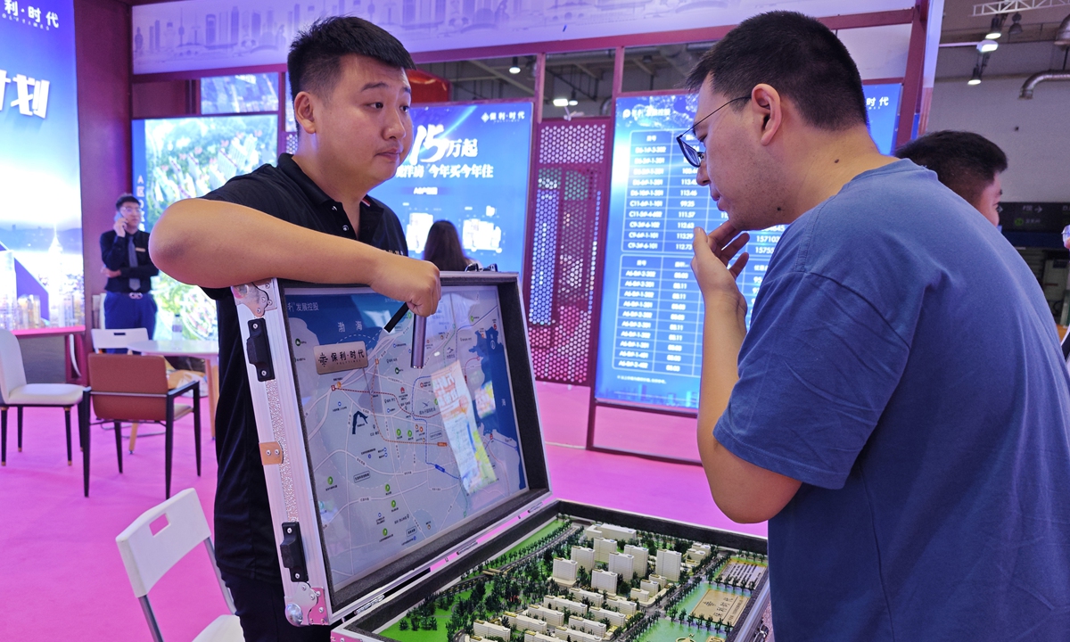 A prospective home buyer listens to an introduction in Dalian, Northeast China's Liaoning Province on September 25, 2023. Photo: VCG